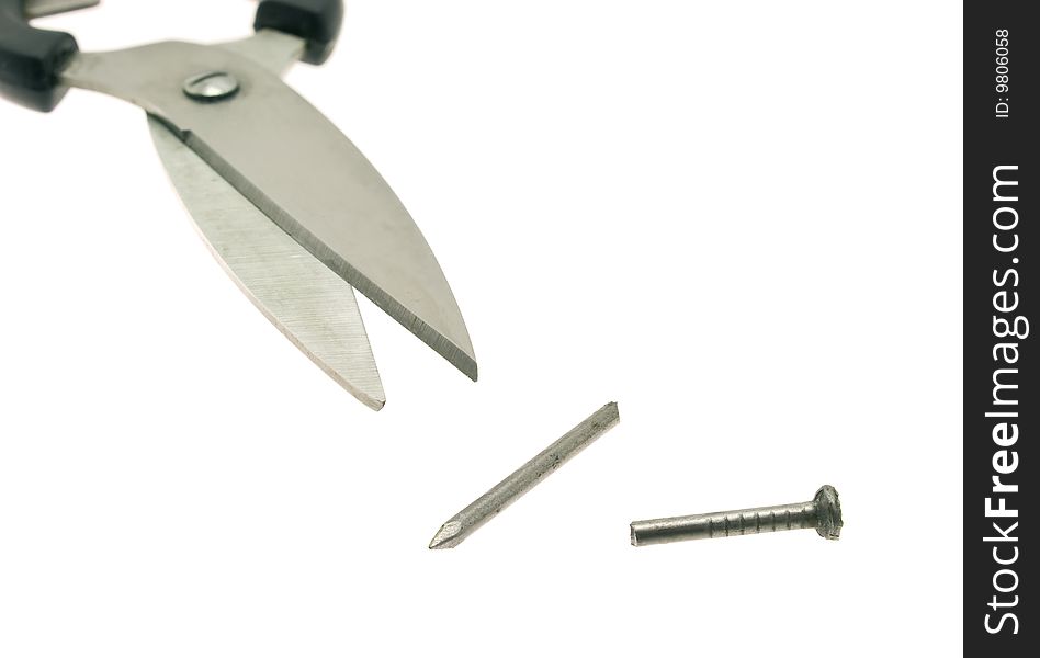 Scissors cutting a nail half-and-half. Scissors cutting a nail half-and-half