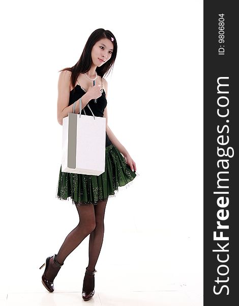 Asian girl holds a shopping bag on white background. Asian girl holds a shopping bag on white background.