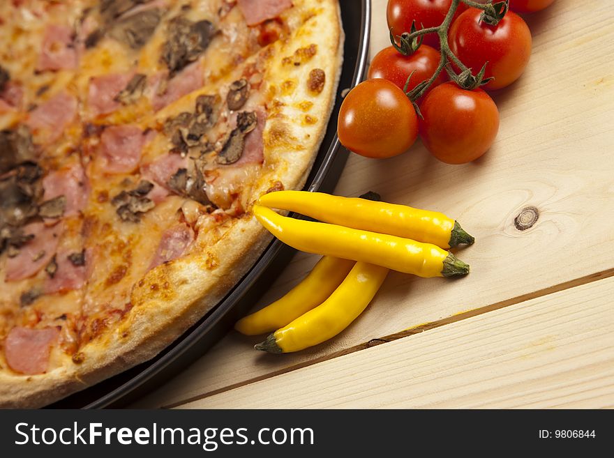 A couple of delicious pizzas, with raw tomatoes, green peppers and mushrooms. A couple of delicious pizzas, with raw tomatoes, green peppers and mushrooms