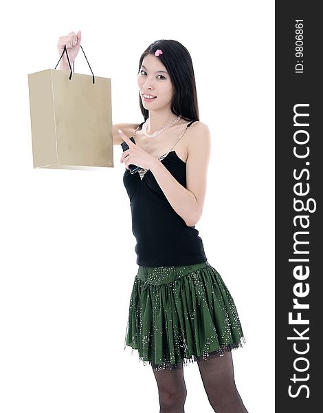 A beautiful Asian girl holds a shopping bag on white background. A beautiful Asian girl holds a shopping bag on white background.