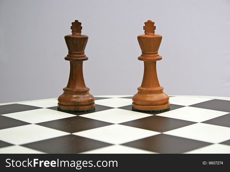 Black and white chess kings on board