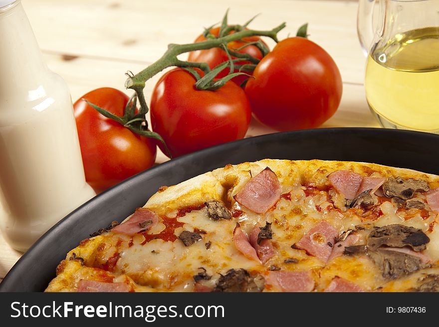 A couple of delicious pizzas, with raw tomatoes, green peppers and mushrooms. A couple of delicious pizzas, with raw tomatoes, green peppers and mushrooms