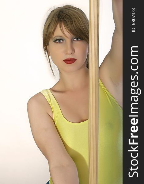 Fitness woman with wooden stick indoor