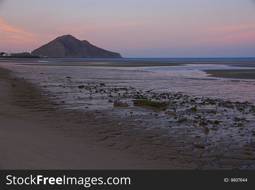 An extreme low tide is accentuated by a purple sunset in San Felipe, Baja California, Mexico. An extreme low tide is accentuated by a purple sunset in San Felipe, Baja California, Mexico.