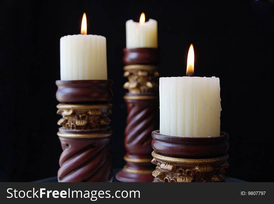 Three candelabra in black background. Three candelabra in black background