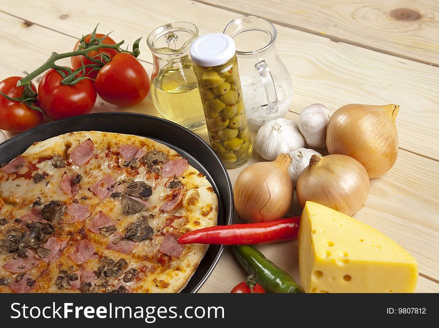 A couple of delicious pizzas, with raw tomatoes, green peppers and mushrooms. A couple of delicious pizzas, with raw tomatoes, green peppers and mushrooms