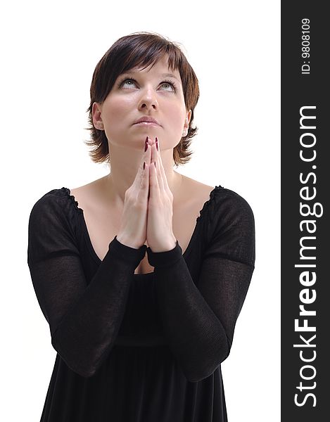 Young woman in black dress praying isolated on white. Young woman in black dress praying isolated on white