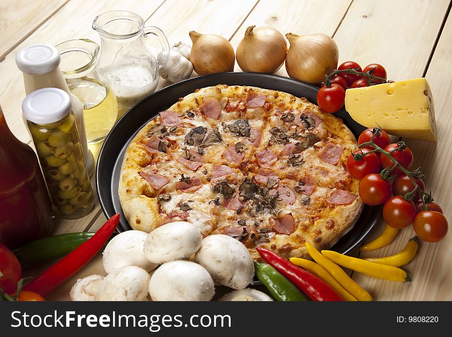 A couple of delicious pizzas, with raw tomatoes, green peppers and mushrooms. A couple of delicious pizzas, with raw tomatoes, green peppers and mushrooms