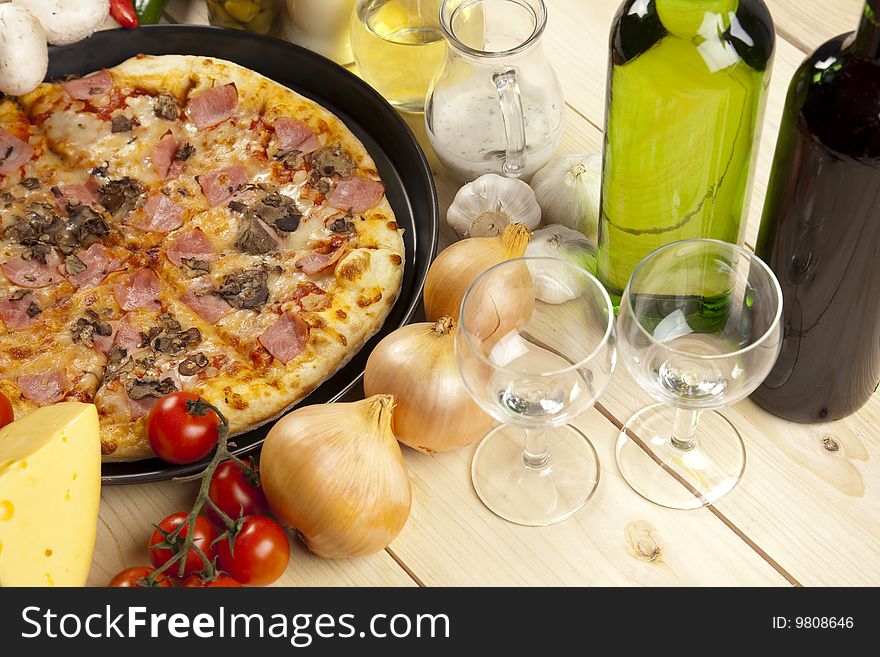 A couple of delicious pizzas, with raw tomatoes, green peppers and mushrooms. A couple of delicious pizzas, with raw tomatoes, green peppers and mushrooms