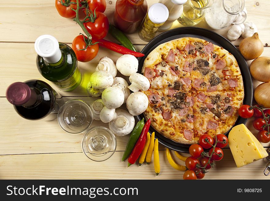 A couple of delicious pizzas, with raw tomatoes, green peppers and mushrooms. A couple of delicious pizzas, with raw tomatoes, green peppers and mushrooms