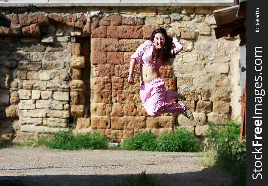 Girl Jumping On Grunge Background