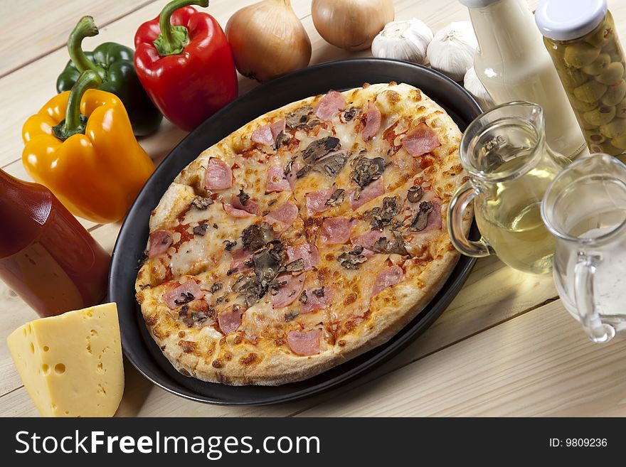 A couple of delicious pizzas, with raw tomatoes, green peppers and mushrooms. A couple of delicious pizzas, with raw tomatoes, green peppers and mushrooms