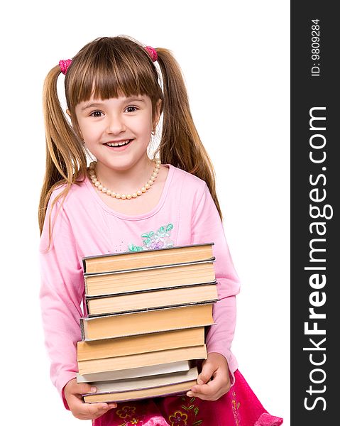 Pretty little girl holding stack of books