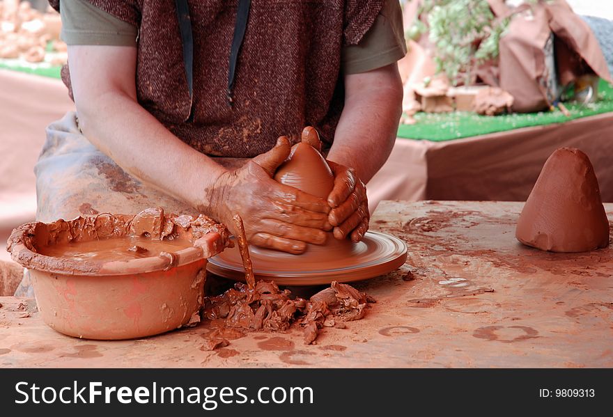 View of a man working on mud. View of a man working on mud