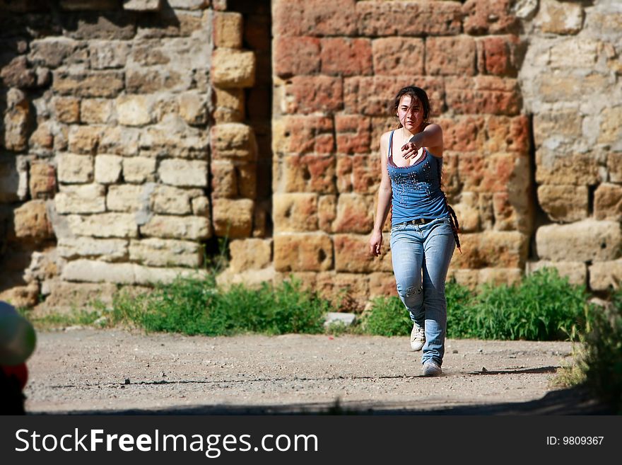 Attractive teen girl walking on grunge background