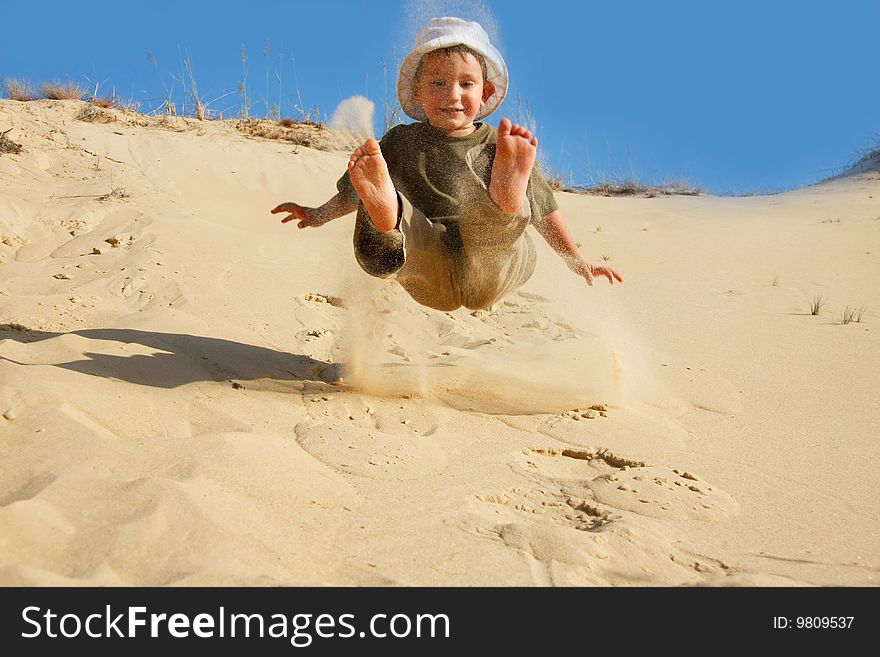 Boy jumping in sands