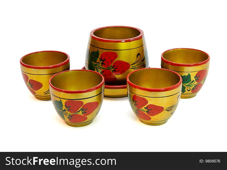 Russian painted wooden pot and four cups isolated. Russian painted wooden pot and four cups isolated