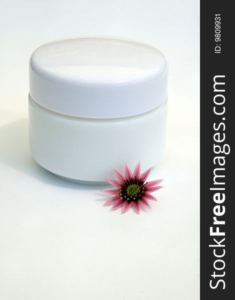 Little white cream jar with flower