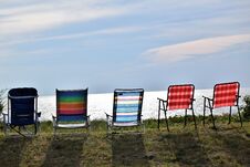 Beach Chairs Lined Up On The Side Of The Bay Royalty Free Stock Photos
