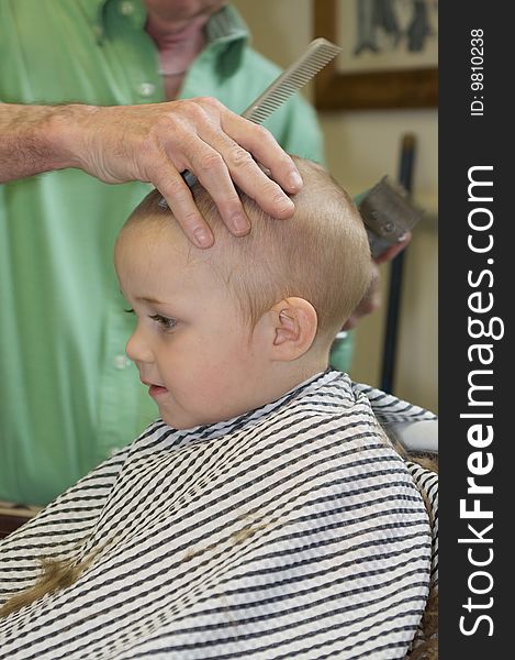 Cute Blue-Eyed Boy Getting his First Hair Cut. Cute Blue-Eyed Boy Getting his First Hair Cut