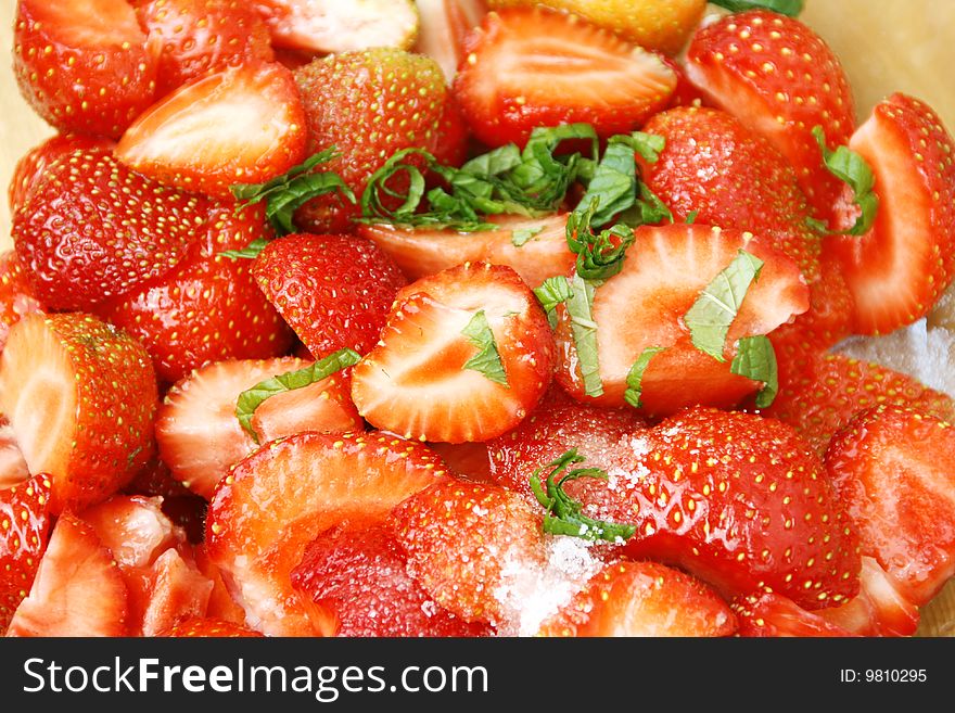 Sliced strawberries with mint and sugar. Sliced strawberries with mint and sugar