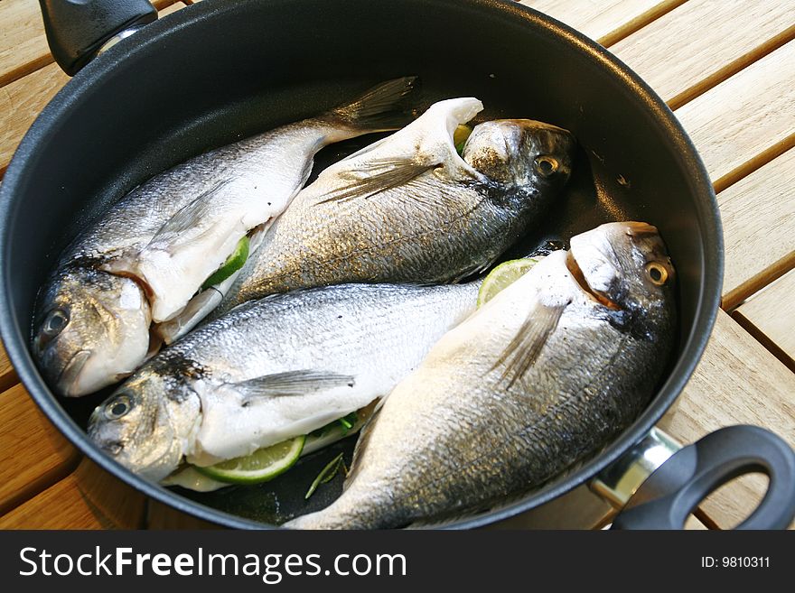 Gilt head sea breams in a pan