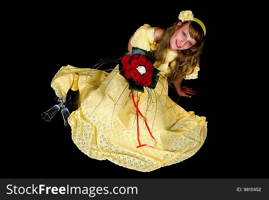 Portrait of a beautiful young bride showing her wedding bouquet of red and white roses on black background, studio shot. Portrait of a beautiful young bride showing her wedding bouquet of red and white roses on black background, studio shot