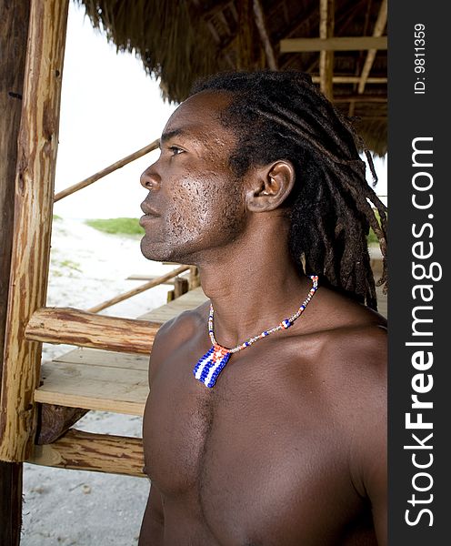 Black man watching away under wood umbrella. Black man watching away under wood umbrella