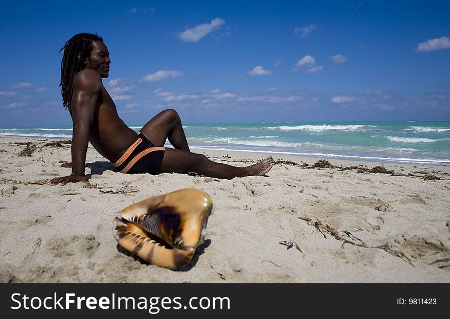 Man sitting on the beach in cuba