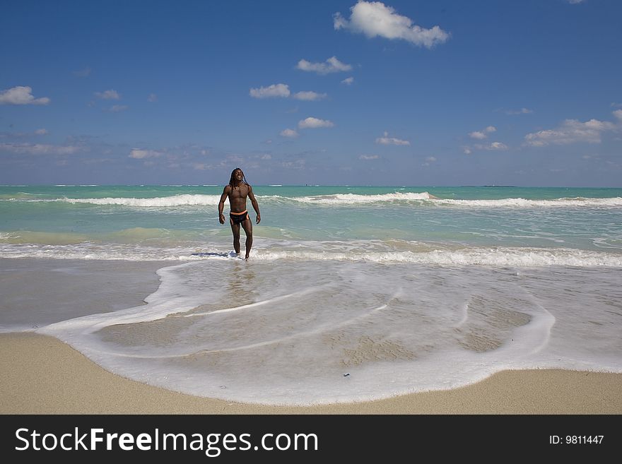 Black man going out the blue sea over blue sky. Black man going out the blue sea over blue sky