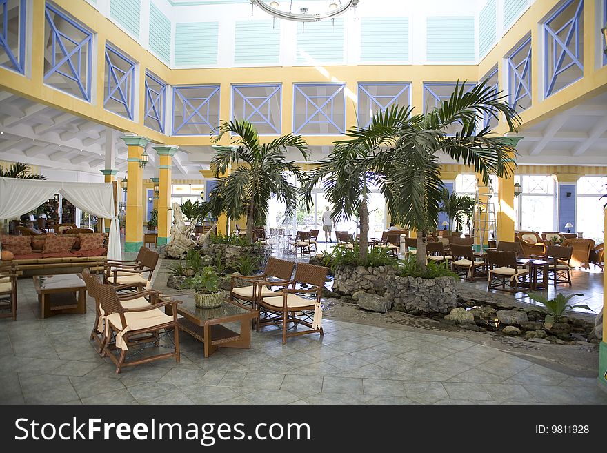 Yellow hotel in cuba with palm trees