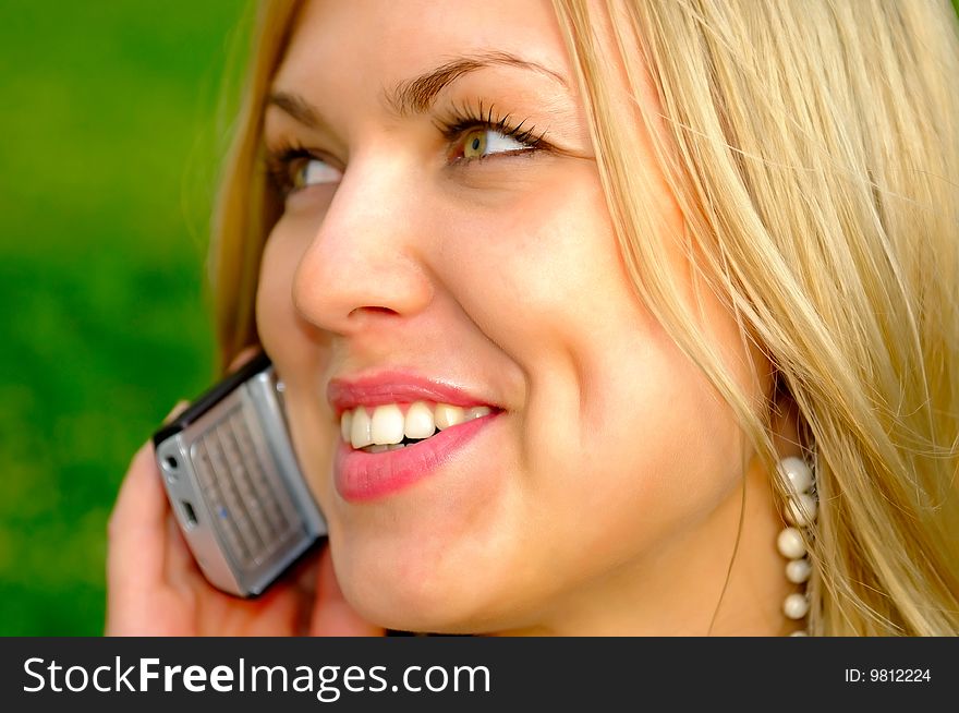 Smiling girl talking by phone. Smiling girl talking by phone