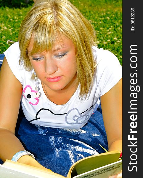 Young attractive woman reading a book. Young attractive woman reading a book