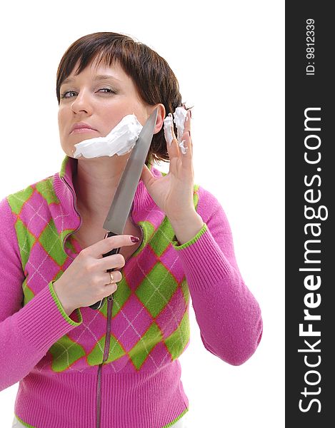 Young woman shaving her face with kitchen knife isolated on white