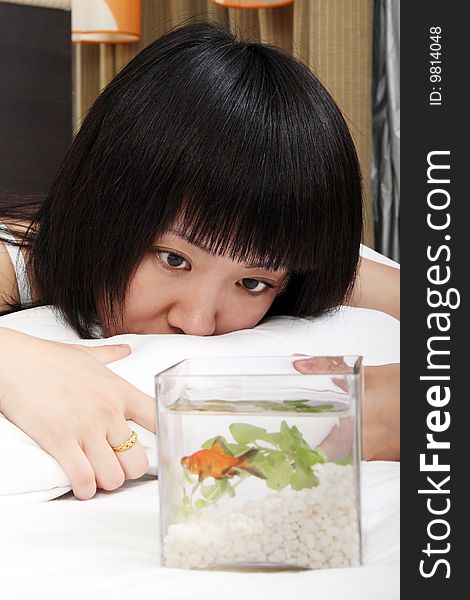 Asian girl with her goldfish