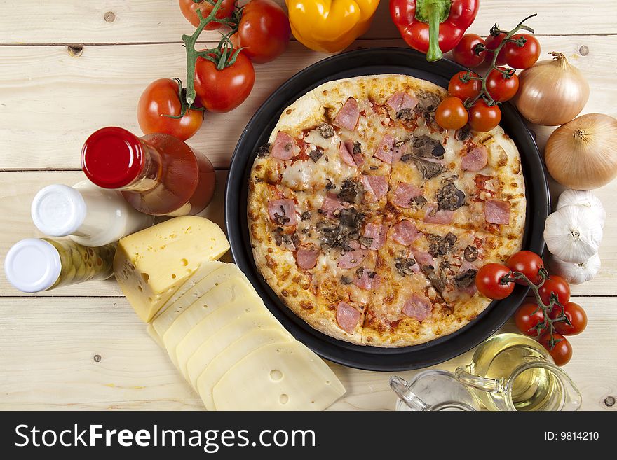 A couple of delicious pizzas, with raw tomatoes, green peppers and mushrooms. A couple of delicious pizzas, with raw tomatoes, green peppers and mushrooms