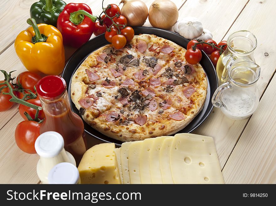 A couple of delicious pizzas, with raw tomatoes, green peppers and mushrooms. A couple of delicious pizzas, with raw tomatoes, green peppers and mushrooms