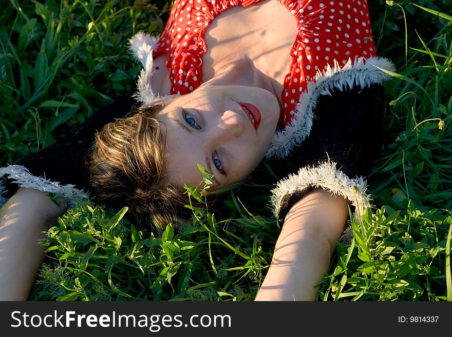 Portrait woman has a rest on grass