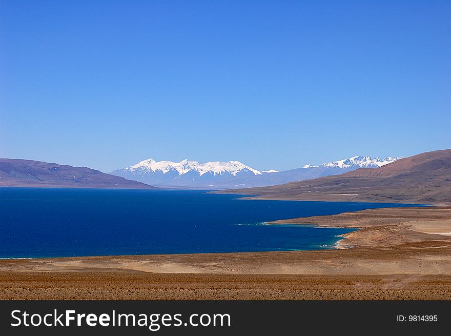 A melted blue lake in the early spring in Tibet. A melted blue lake in the early spring in Tibet