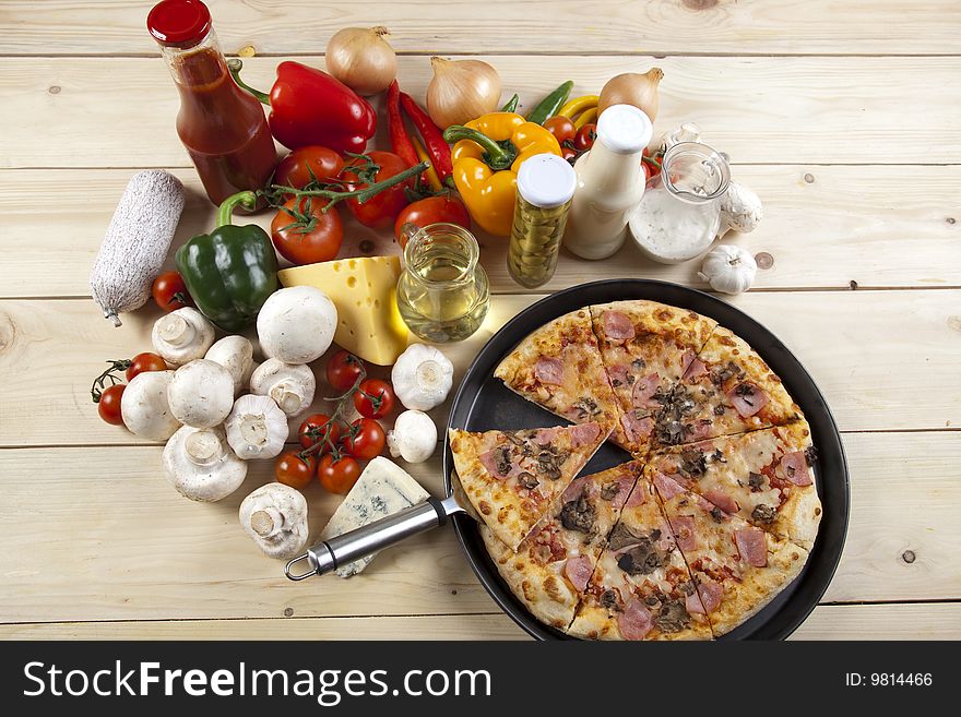 A couple of delicious pizzas, with raw tomatoes, green peppers and mushrooms. A couple of delicious pizzas, with raw tomatoes, green peppers and mushrooms