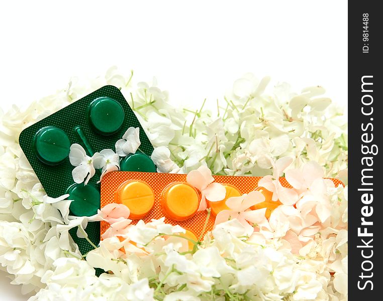 Homoeopathic pills and white flowers. Homoeopathic pills and white flowers