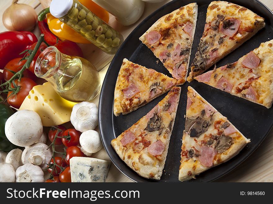 A couple of delicious pizzas, with raw tomatoes, green peppers and mushrooms. A couple of delicious pizzas, with raw tomatoes, green peppers and mushrooms