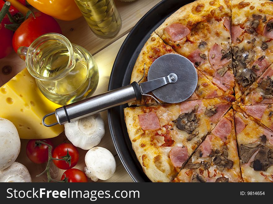 A couple of delicious pizzas, with raw tomatoes, green peppers and mushrooms. A couple of delicious pizzas, with raw tomatoes, green peppers and mushrooms