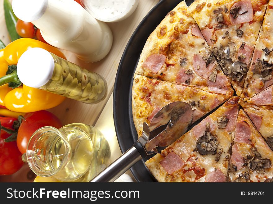 A couple of delicious pizzas, with raw tomatoes, green peppers and mushrooms. A couple of delicious pizzas, with raw tomatoes, green peppers and mushrooms