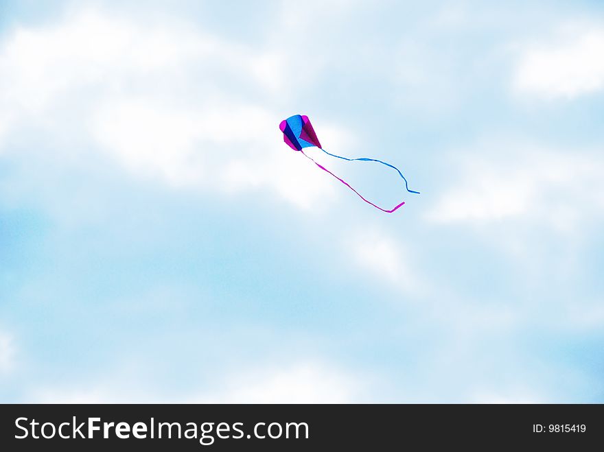Colorful kite soaring in the cloudy sky