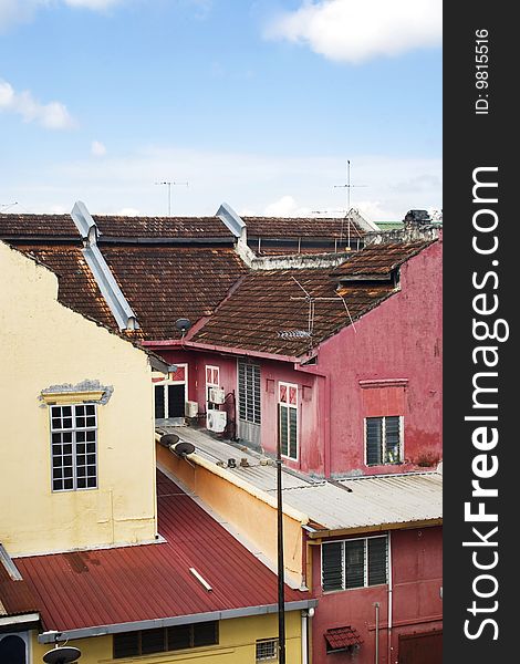 A row of old colorful houses against blue sky