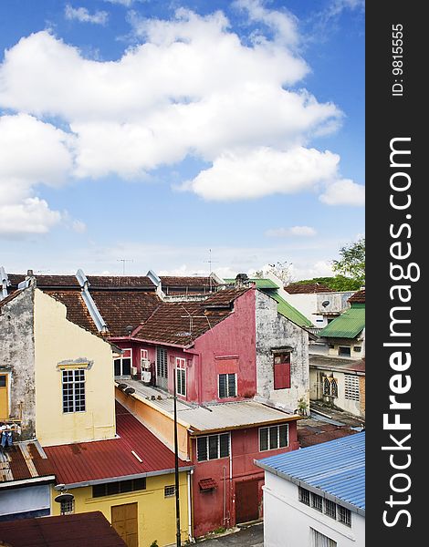 A row of old colorful houses against blue sky