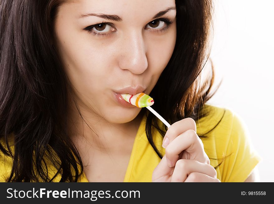 Young girl with lollipop isolated on white