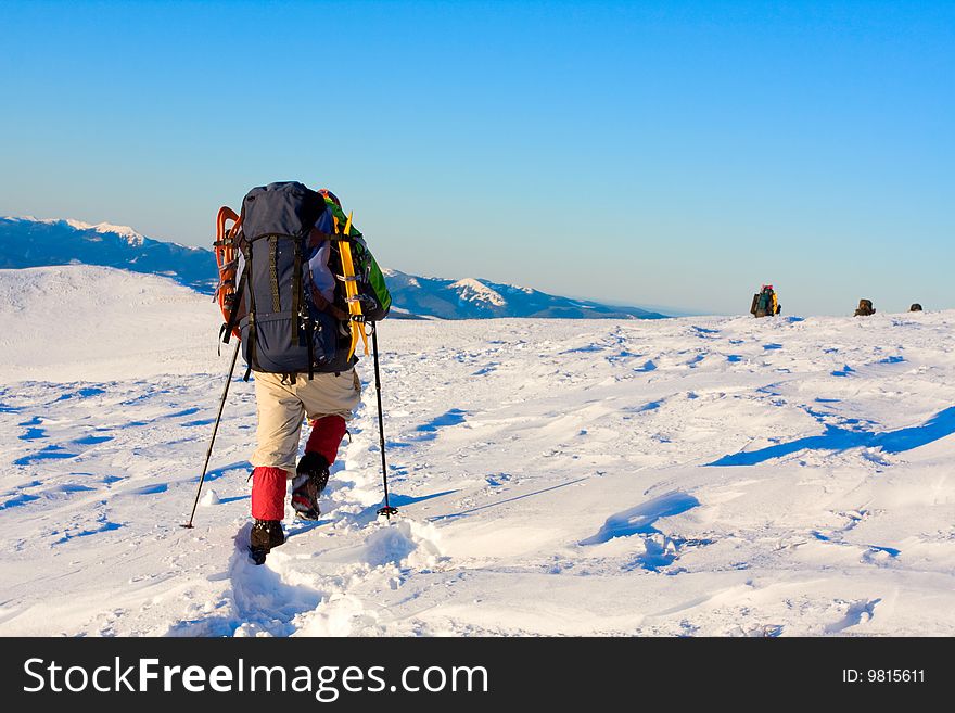 Hiker in high winter mountains