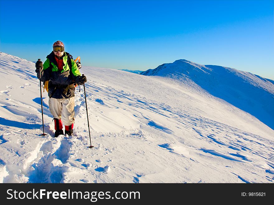 Hiker in high winter mountains